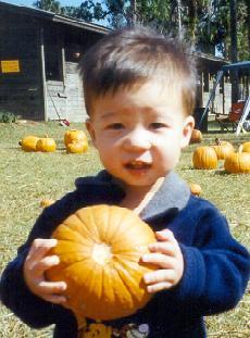 Ryan picking out his first pumpkin (10/30/2001)