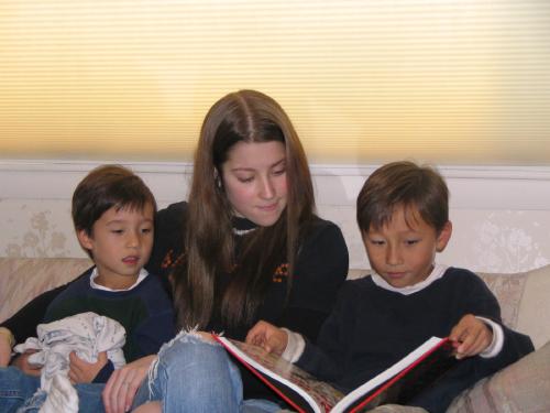 The boys and Rachel reading 'Dragonology'